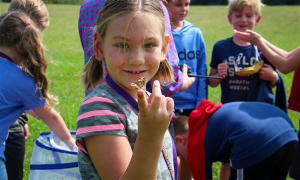 Girl holds up butterfly